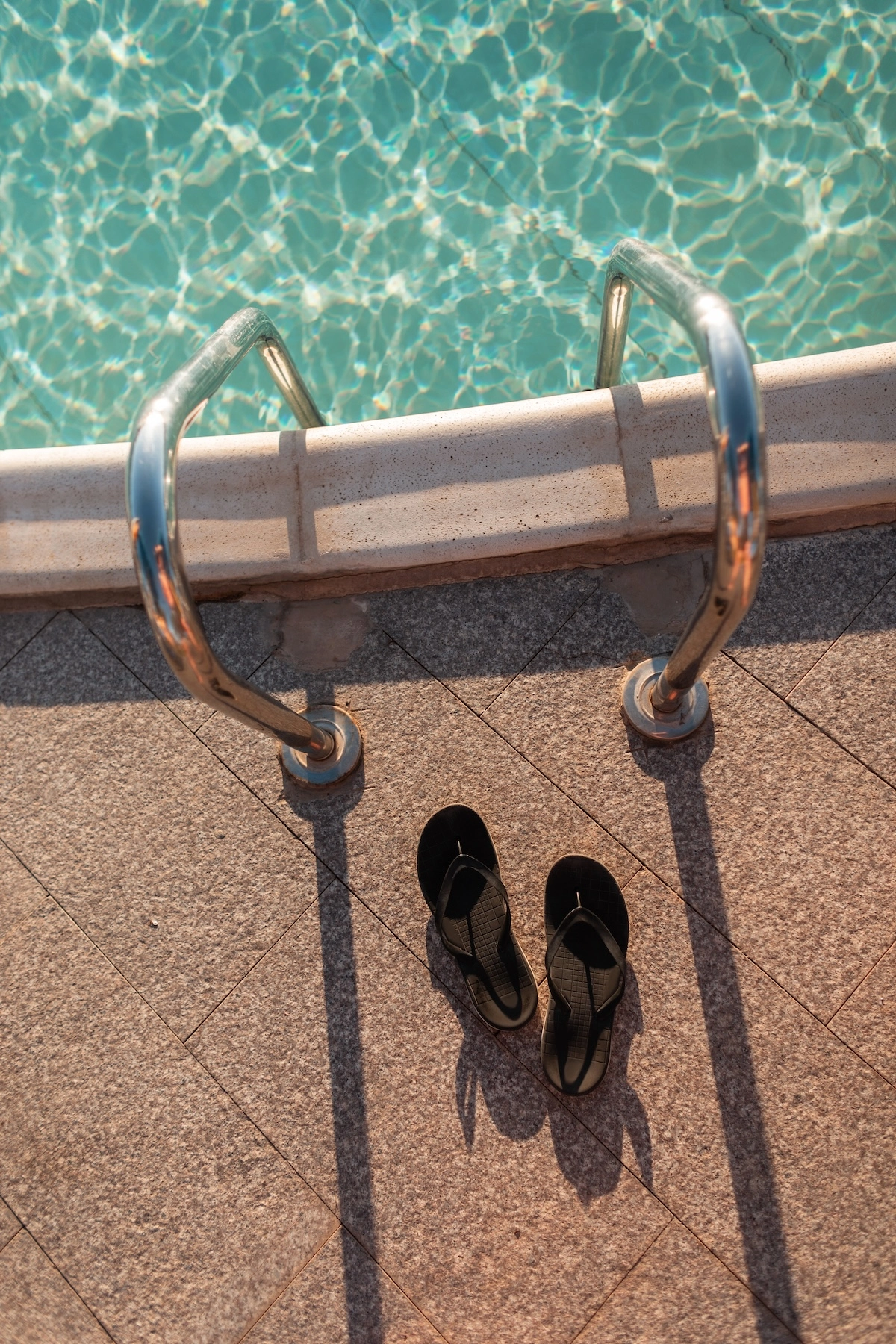 Azure pool with sun loungers on a bright terrace